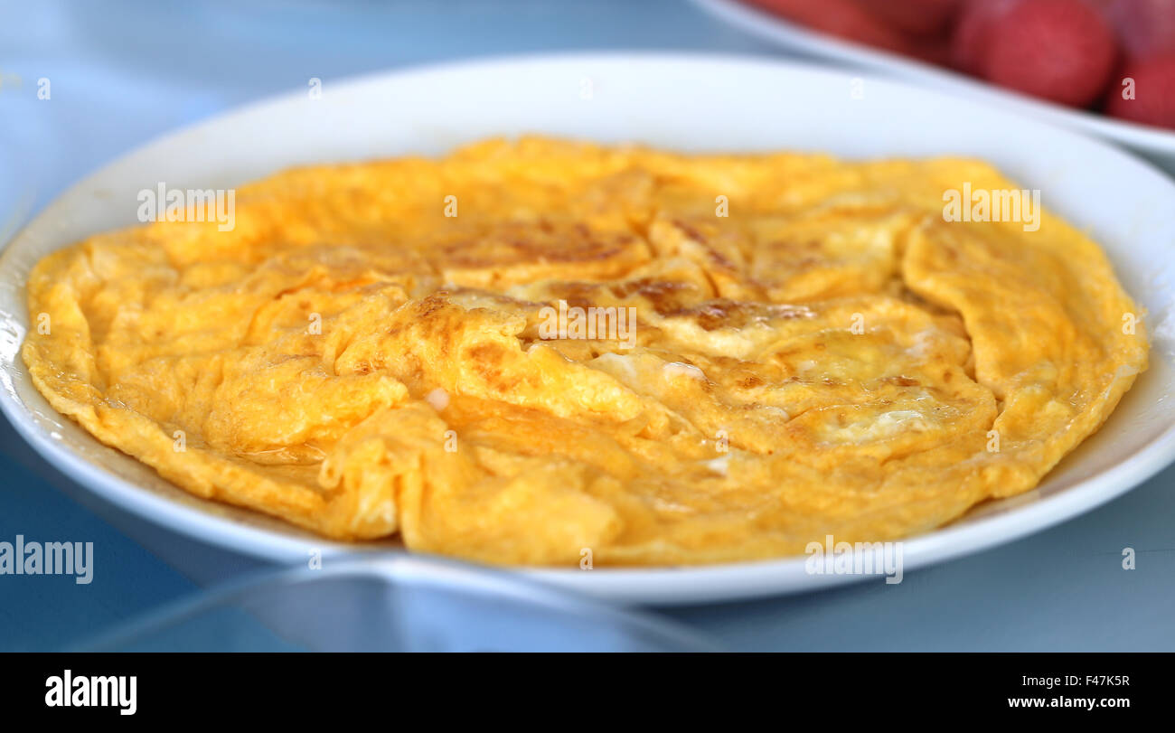 Delicious omelet on a white plate photographed close up Stock Photo