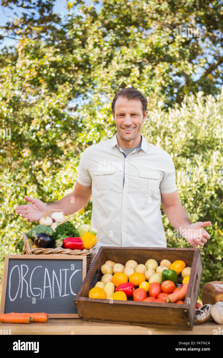 Smiling farmer holding a basket of vegetables Stock Photo - Alamy