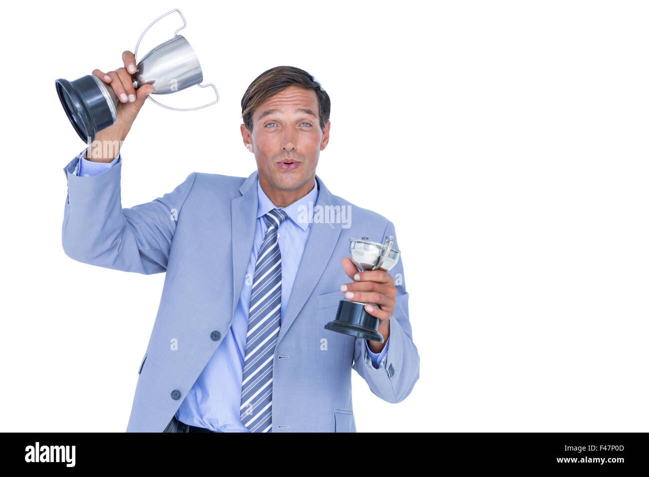 Happy businessman holding a trophy Stock Photo - Alamy
