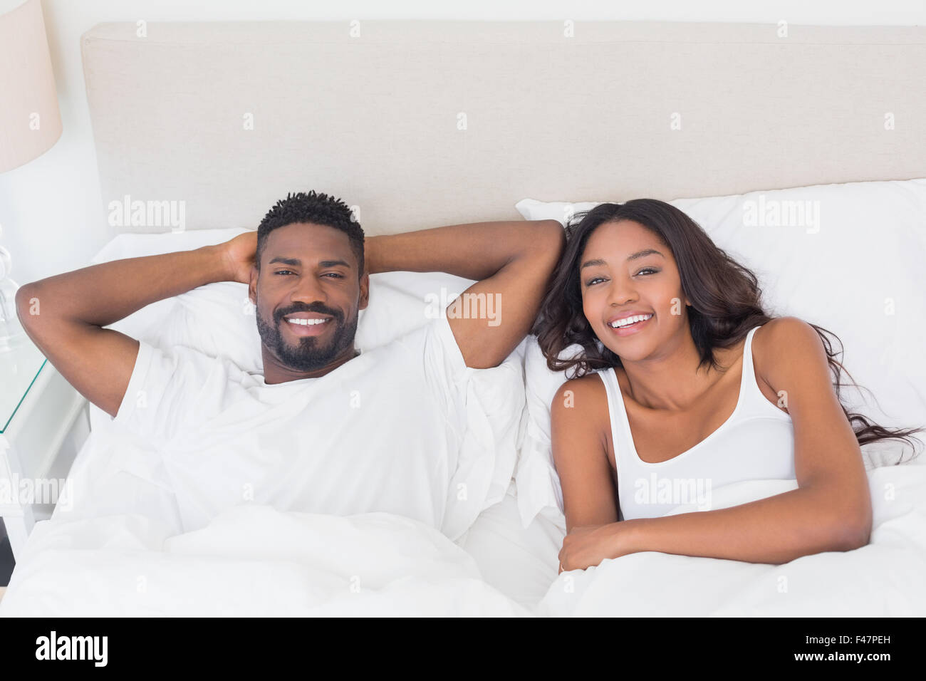 Couple lying in bed together hi-res stock photography and images - Alamy