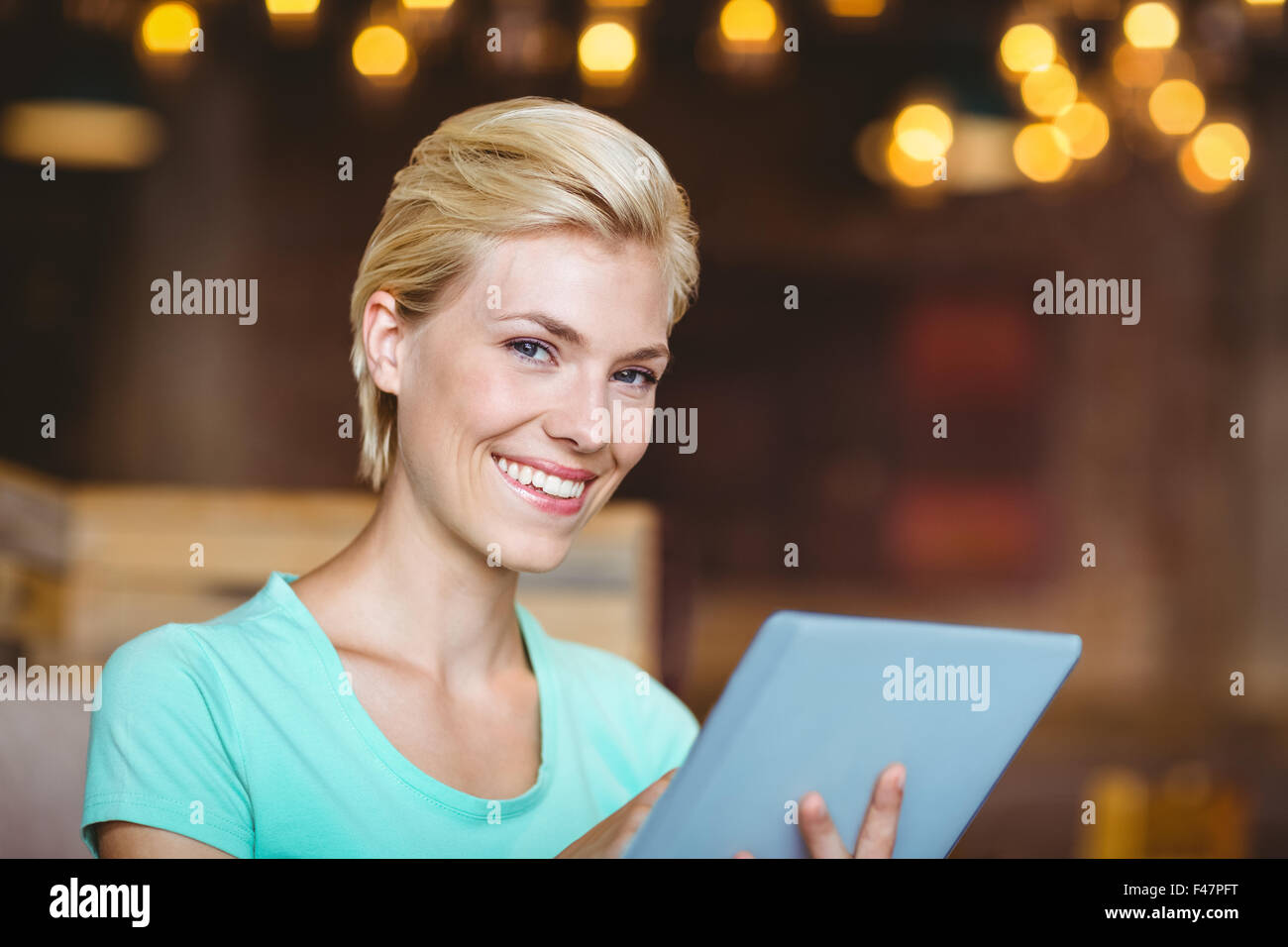 Pretty blonde using tablet computer Stock Photo
