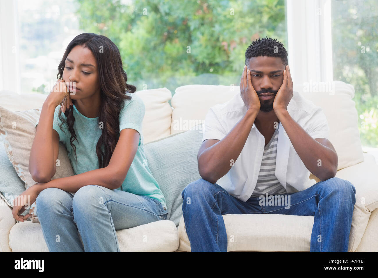 Couple having argument on the couch Stock Photo - Alamy