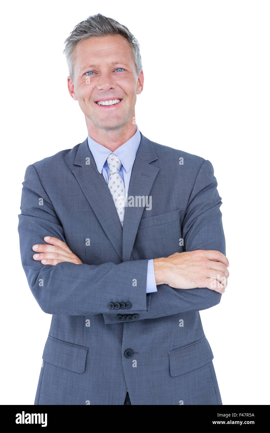 Smiling businessman with arms crossed Stock Photo - Alamy