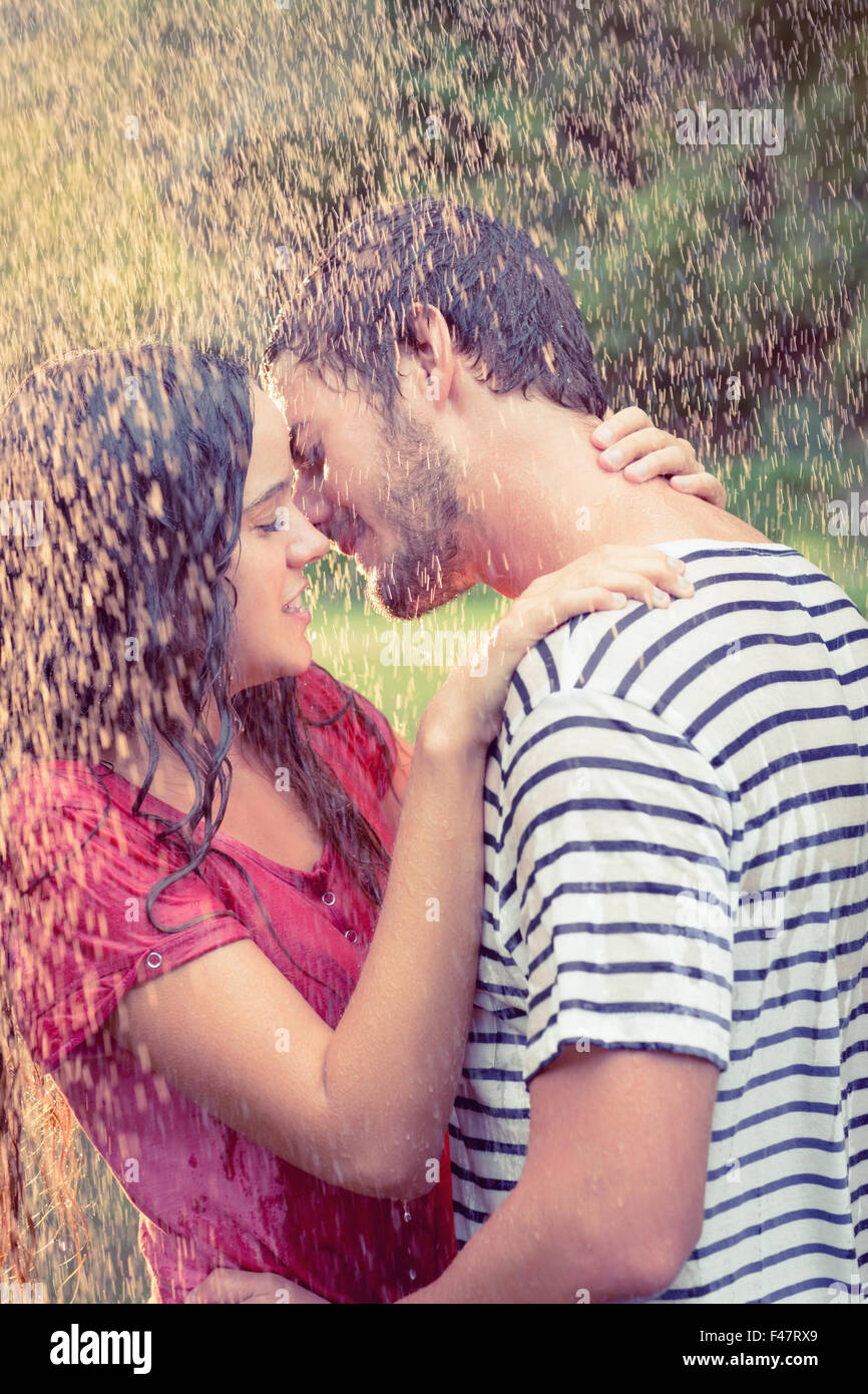 Cute couple hugging under the rain Stock Photo - Alamy