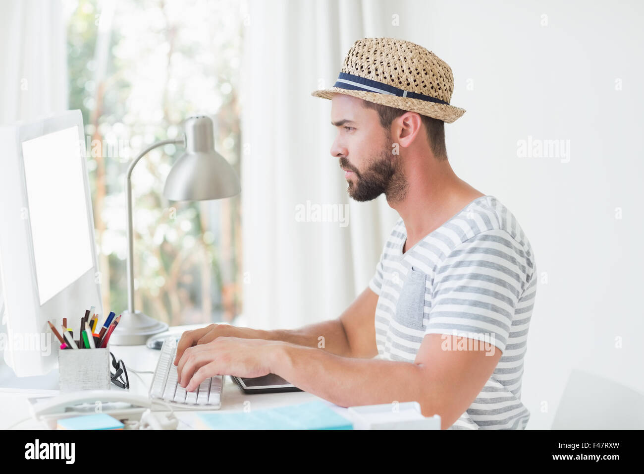 Happy handsome man using computer Stock Photo - Alamy