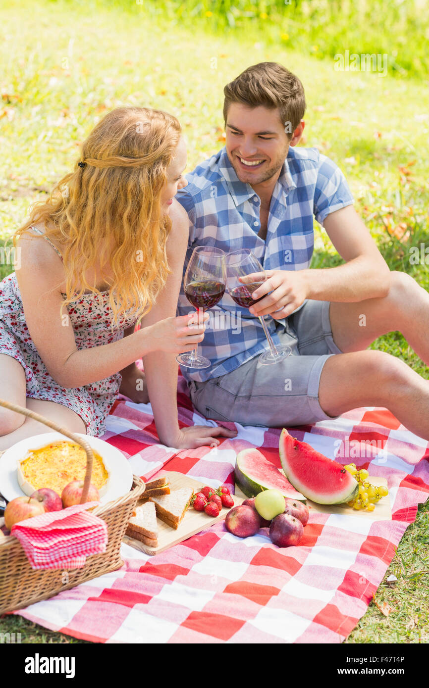 Young couple on a picnic drinking wine Stock Photo - Alamy