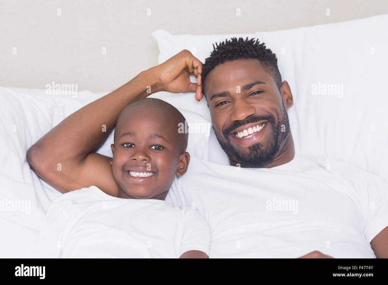 Father and son smiling at camera Stock Photo - Alamy
