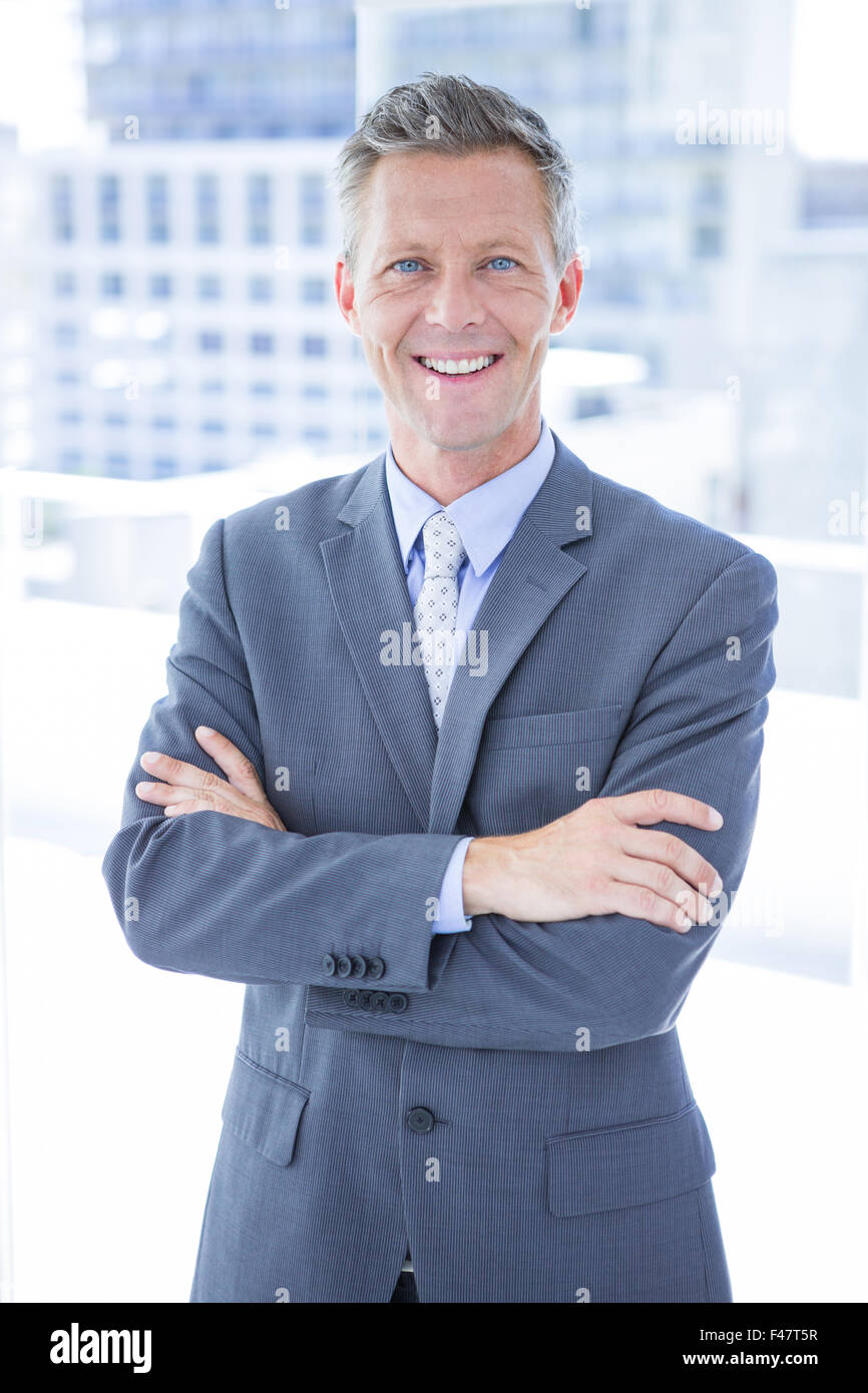 Smiling businessman looking at camera Stock Photo - Alamy