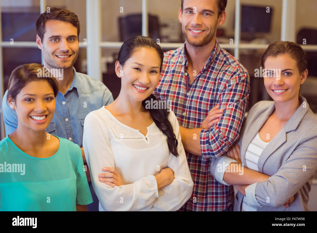 Creative business team looking at the camera Stock Photo - Alamy