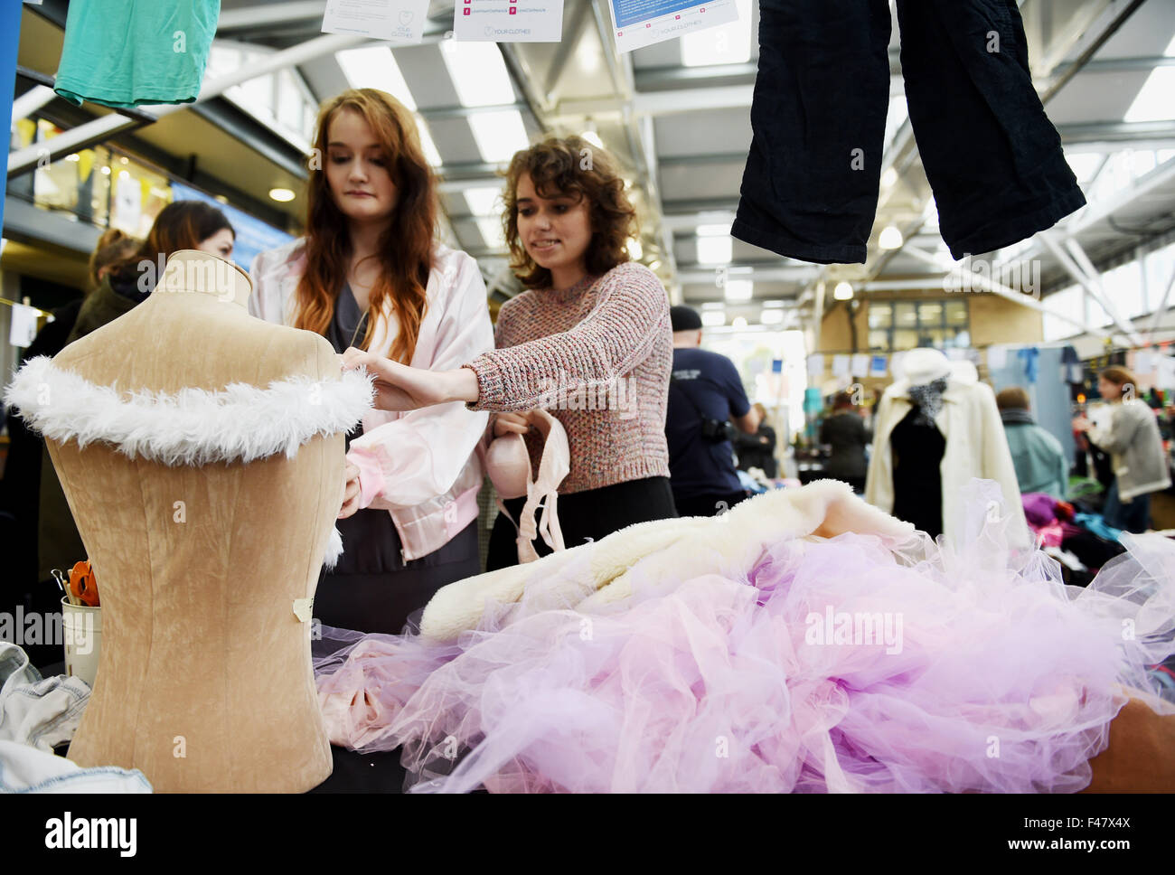 Brighton, UK. 15th October, 2015. Darcy Taylor and Daisy Hills both students from Northbrook College create outfits with a princess theme from the tonne of clothes mountain at the Brighton Indoor Market where they were taking part in the Fashion Salvage Challenge which is part of Brighton Fashion Week . They were given four hours to pick items from the tonne of clothes and with help from experts on hand challenged to create any design of their choice The event is held in conjunction with cancer Research UK , Wrap and Your Clothes Stock Photo