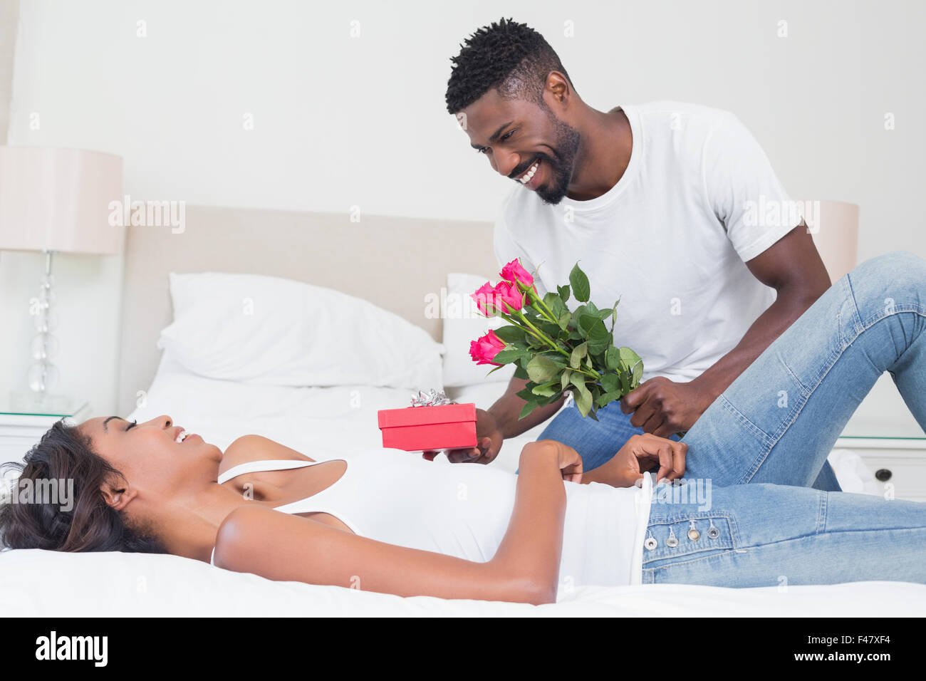Romantic man giving roses to partner Stock Photo Alamy