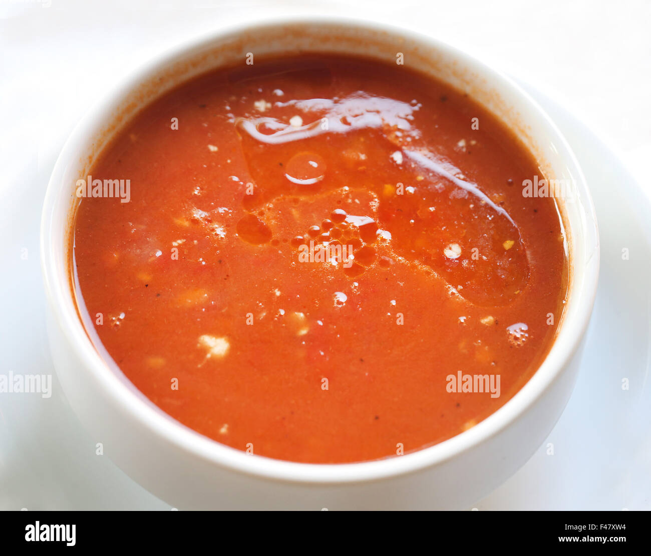 Tasty tomato soup in a plate is photographed close-up Stock Photo