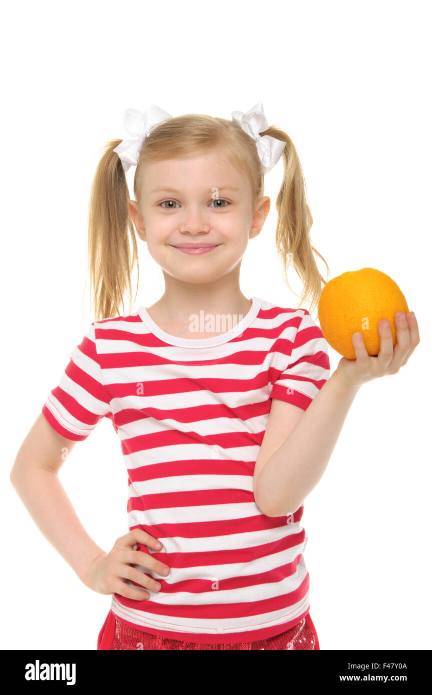girl holding an orange and smiling Stock Photo - Alamy
