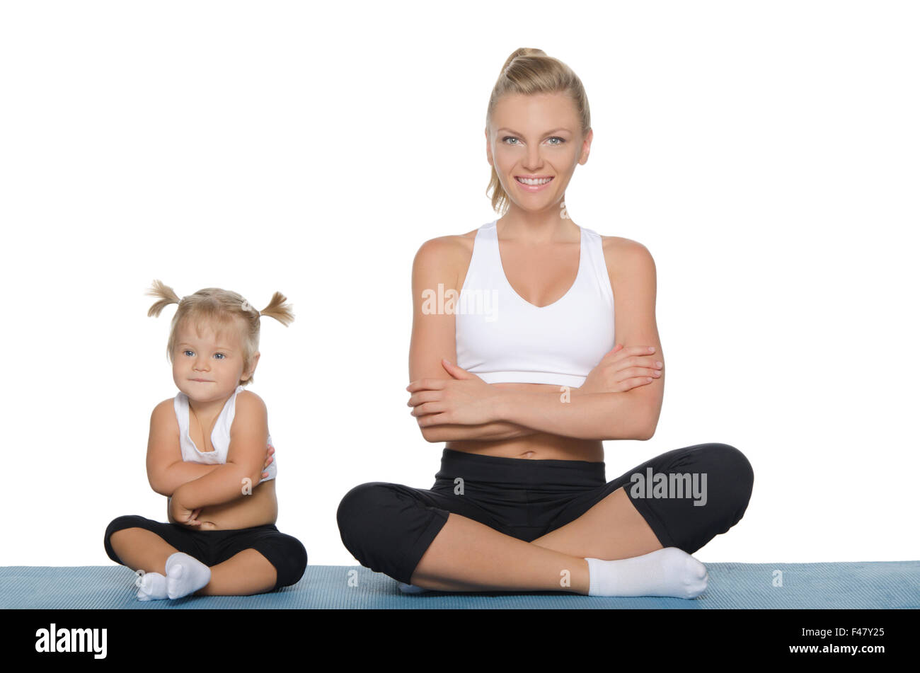 Mom and daughter engage in fitness on mat Stock Photo