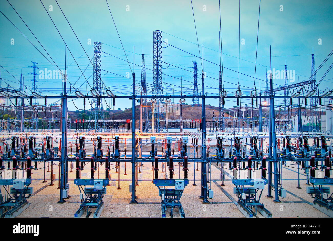 Power station for making Electricity. Shot before sunrise with cable red hot Stock Photo