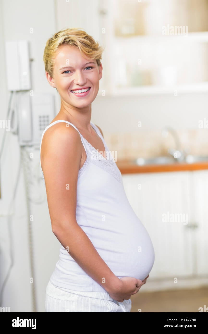 Pregnant woman cuddling her stomach Stock Photo Alamy