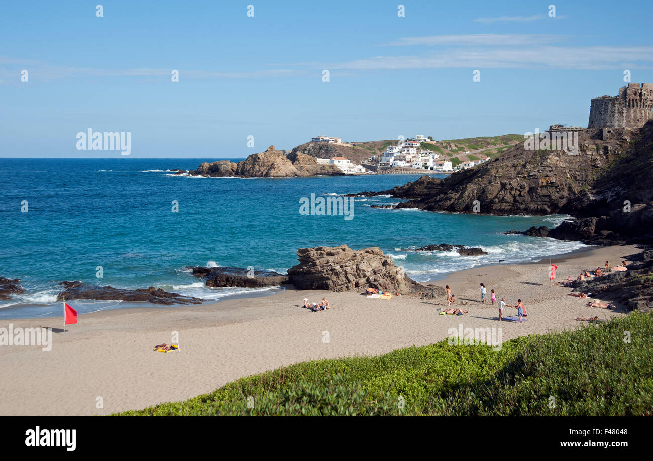 Cala Mesquida beach with rocks and coastal defence tower overlooking on the island of Menorca Spain Stock Photo