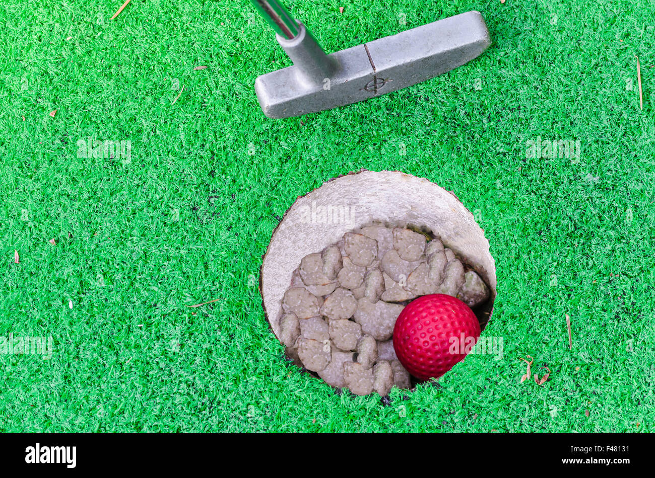 Close-up Mini Golf hole with bat and ball Stock Photo