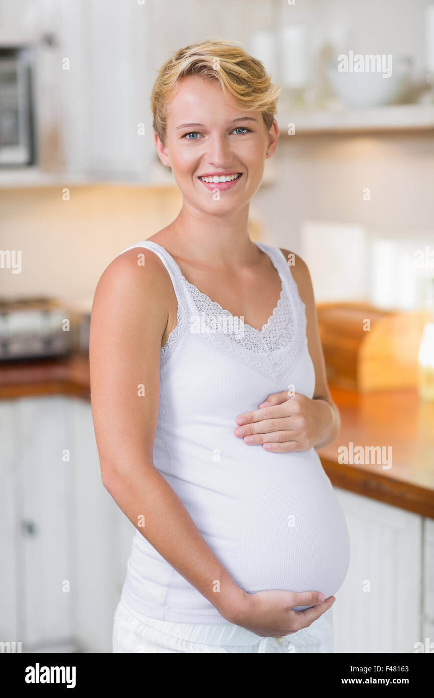 Pregnant woman cuddling her stomach Stock Photo Alamy