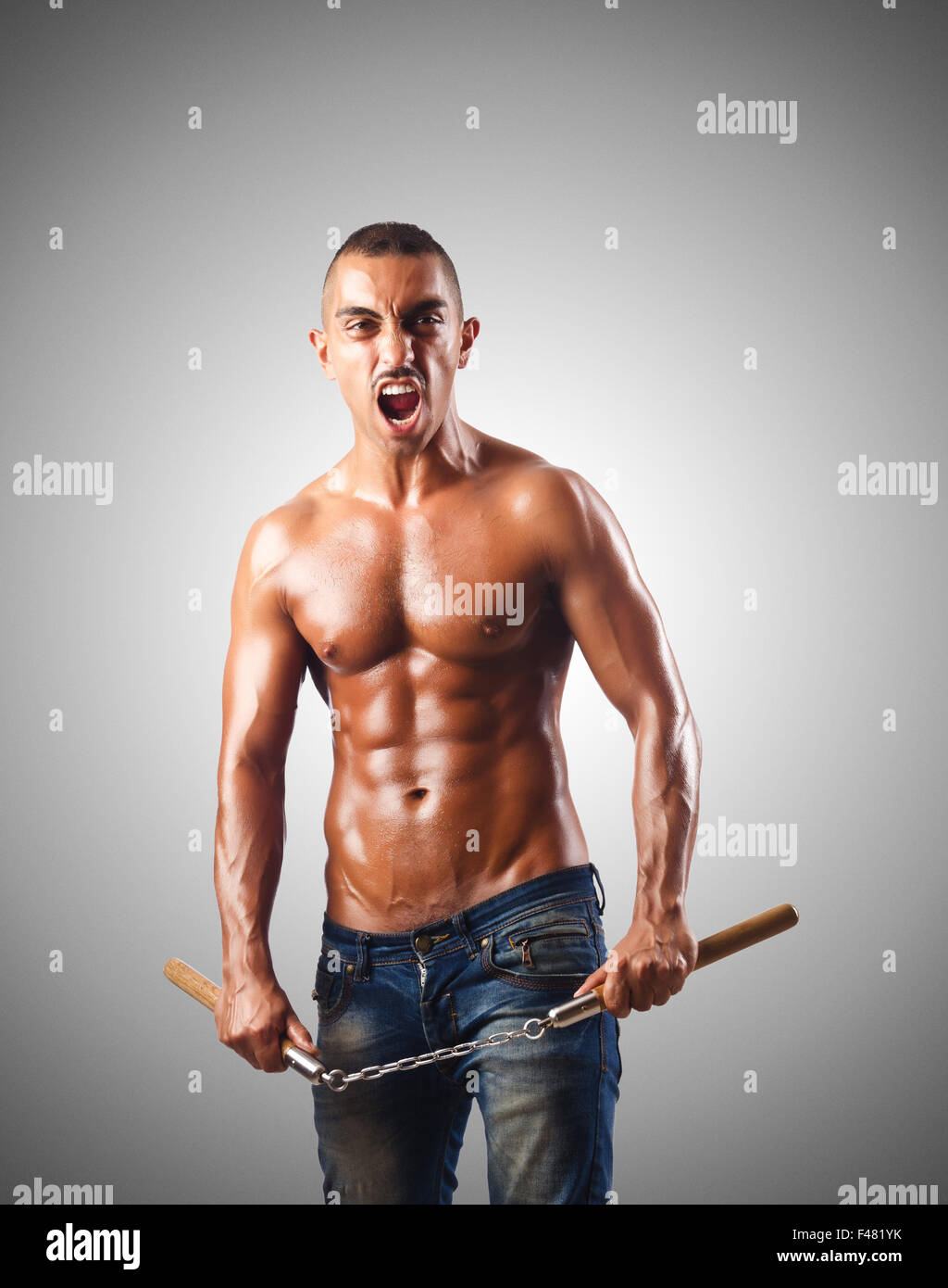 Man in martial arts concept with nunchucks Stock Photo Alamy