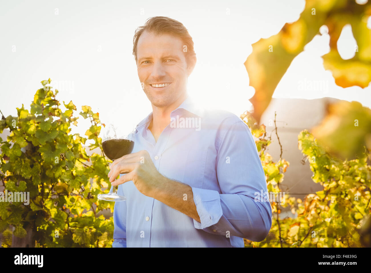 Smiling man with red wine glass Stock Photo - Alamy