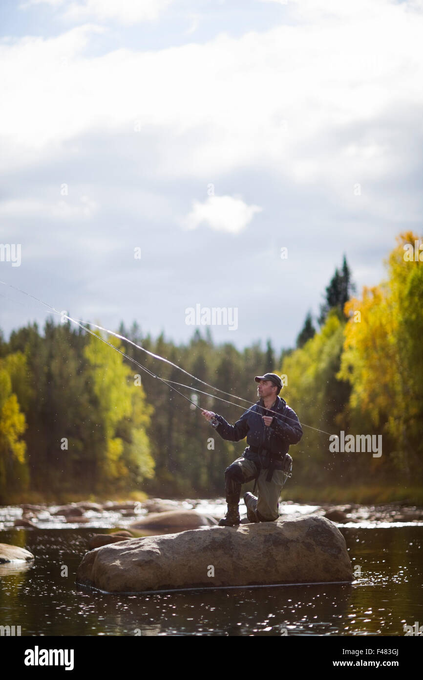 A man fly-fishing, Sweden Stock Photo - Alamy