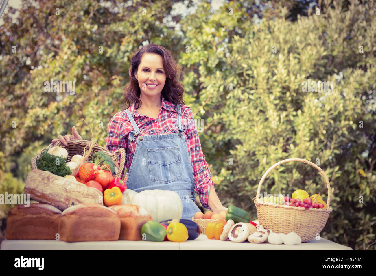 Smiling farmer holding a basket of vegetables Stock Photo - Alamy