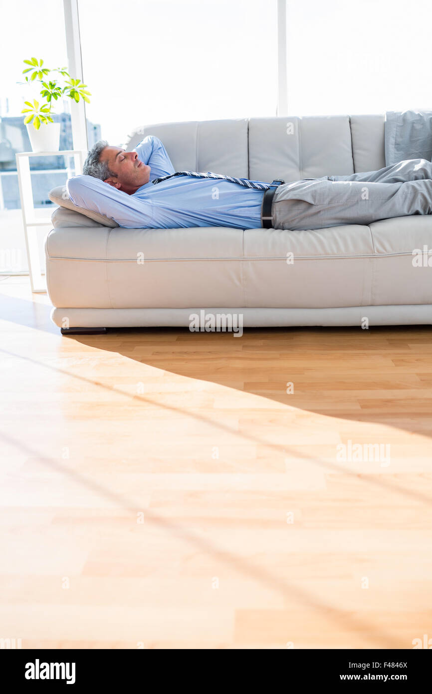 Businessman relaxing on a couch Stock Photo