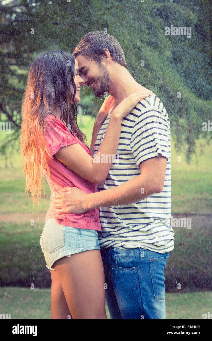 Cute couple hugging under the rain Stock Photo - Alamy