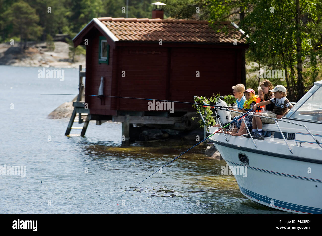 children-fishing-from-a-motorboat-sweden-stock-photo-alamy