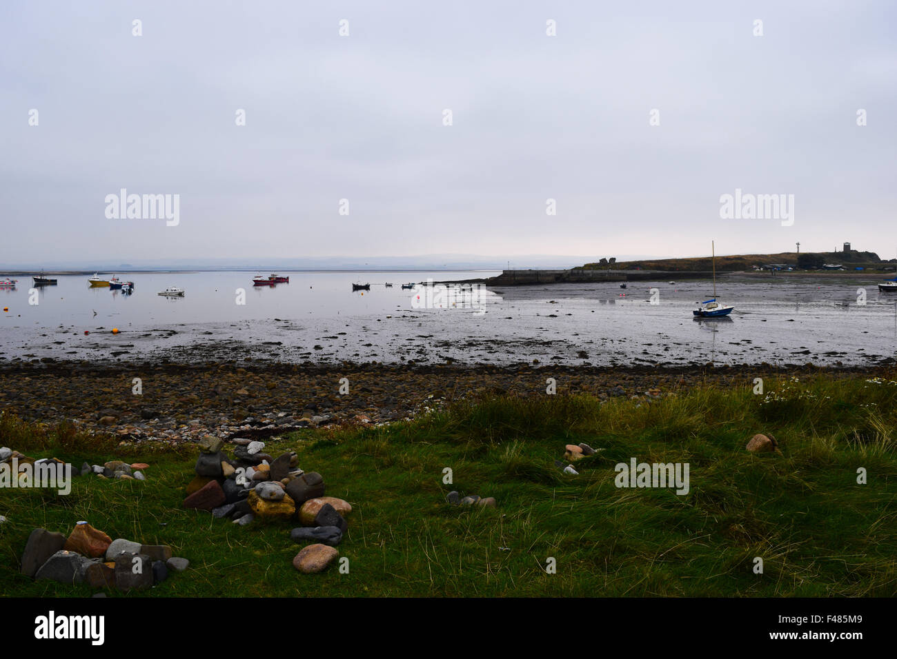 Looking out over Lindisfarne harbour, Northumberland on an overcast day. Stock Photo