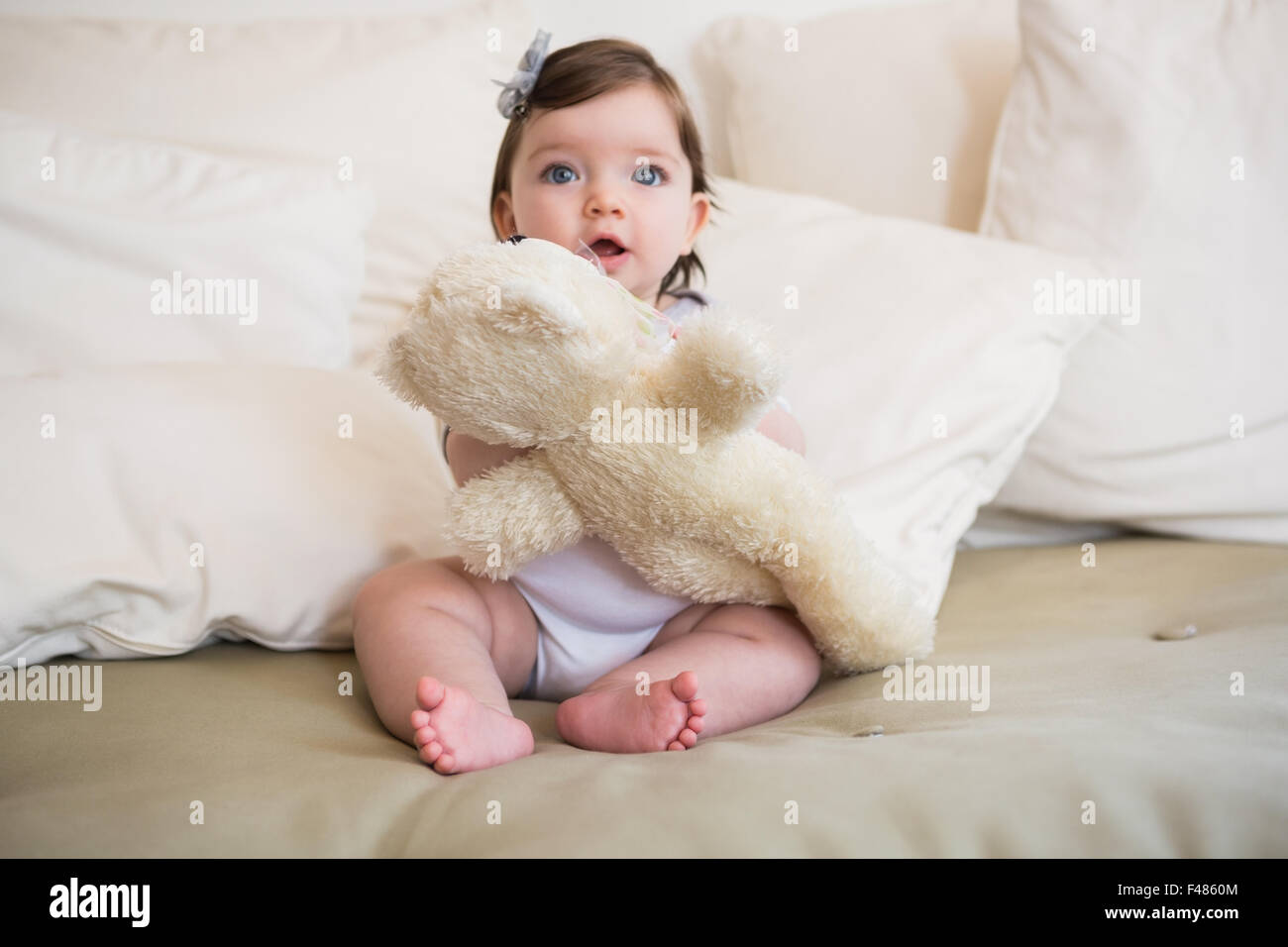Beautiful cute baby girl with her teddy bear Stock Photo - Alamy