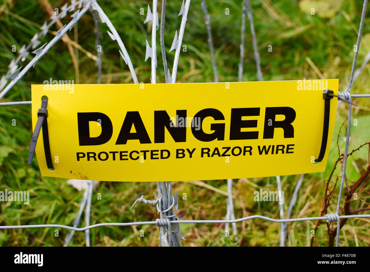 Danger razor wire warning sign. Stock Photo