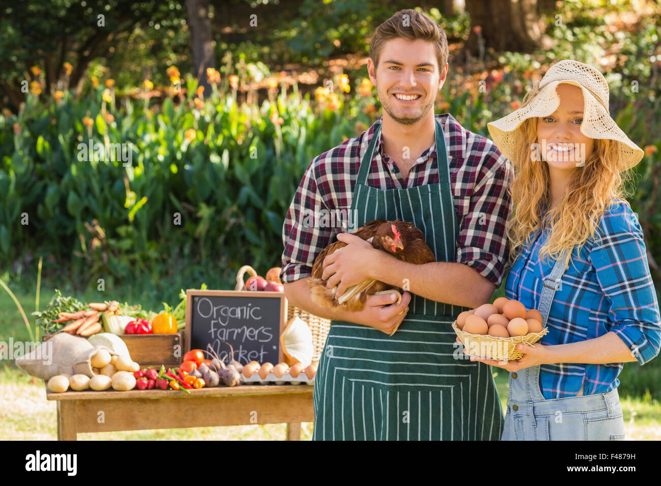 Couple selling organic vegetables at market Stock Photo - Alamy