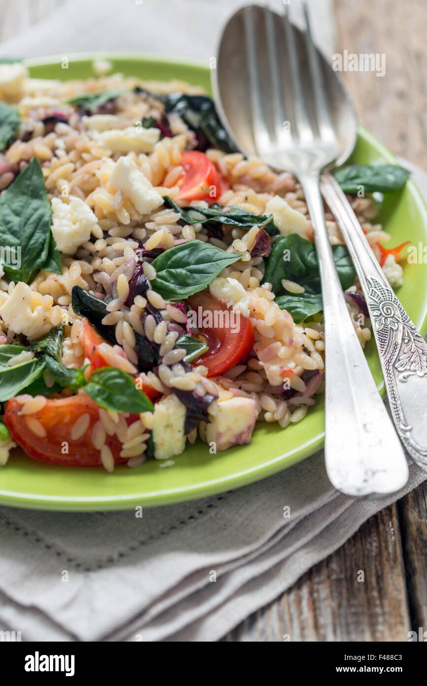 Pasta with cheese, tomatoes and basil. Stock Photo