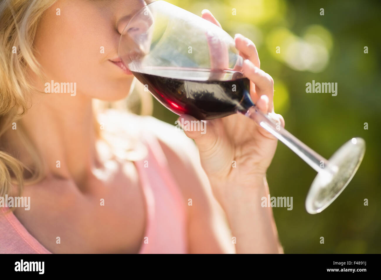 Close up view of blonde woman drinking red wine Stock Photo