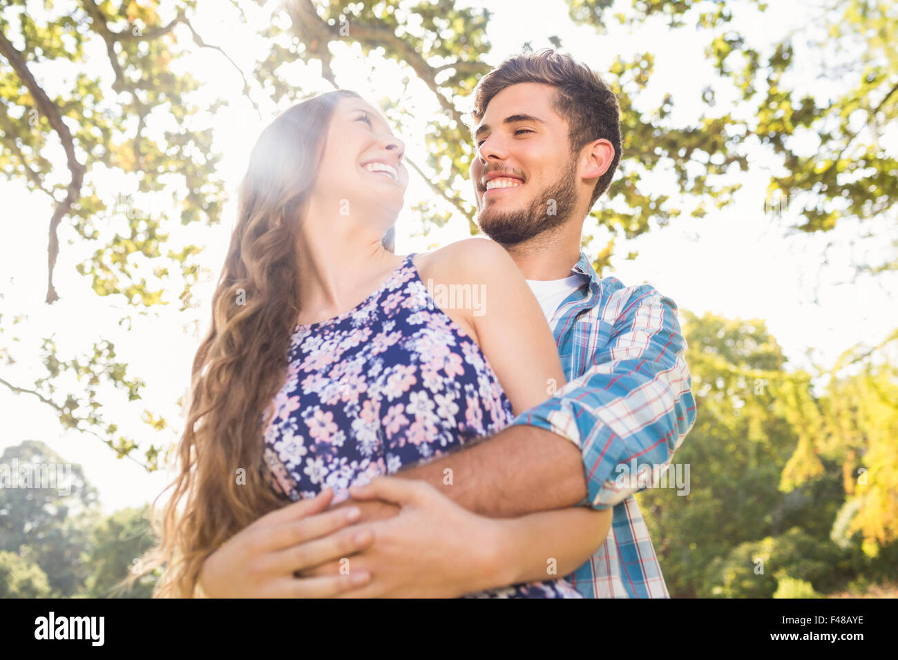 Cute couple hugging in the park Stock Photo - Alamy