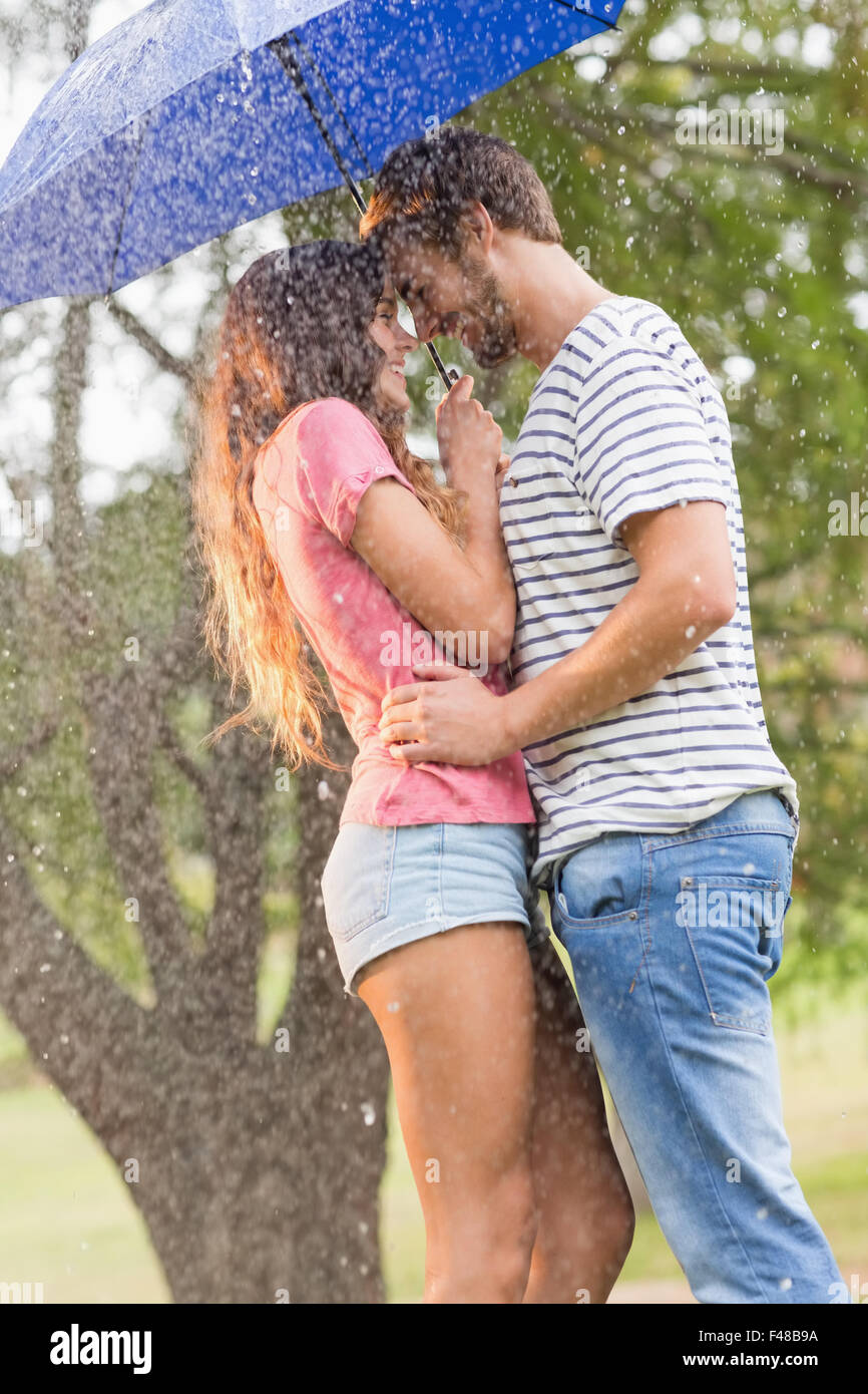 https://c8.alamy.com/comp/F48B9A/cute-couple-hugging-under-the-umbrella-F48B9A.jpg