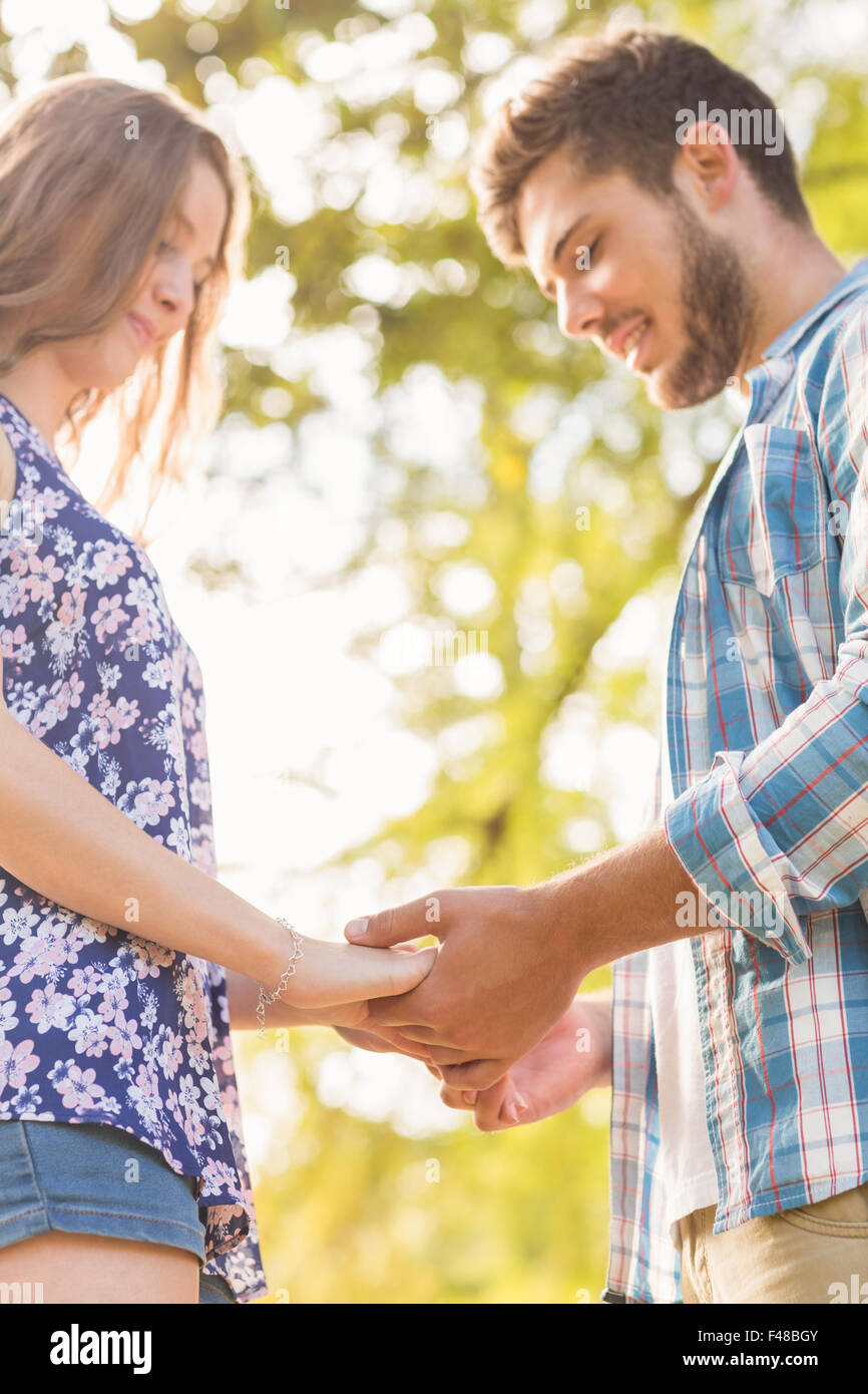 Cute couple holding hands in the park Stock Photo - Alamy