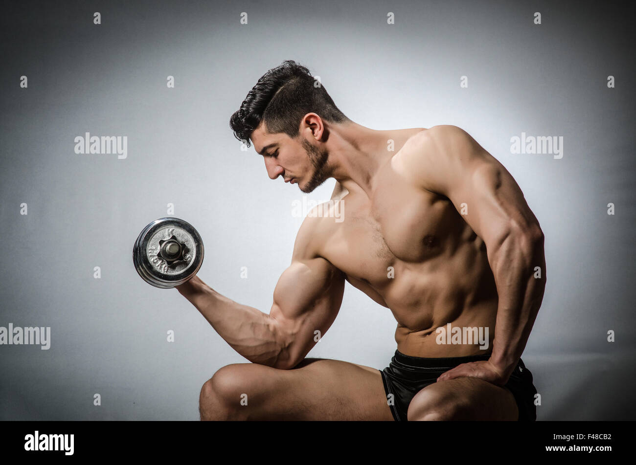Bodybuilding Ripped Model Muscular ripped bodybuilder with dumbbells Stock Photo - Alamy