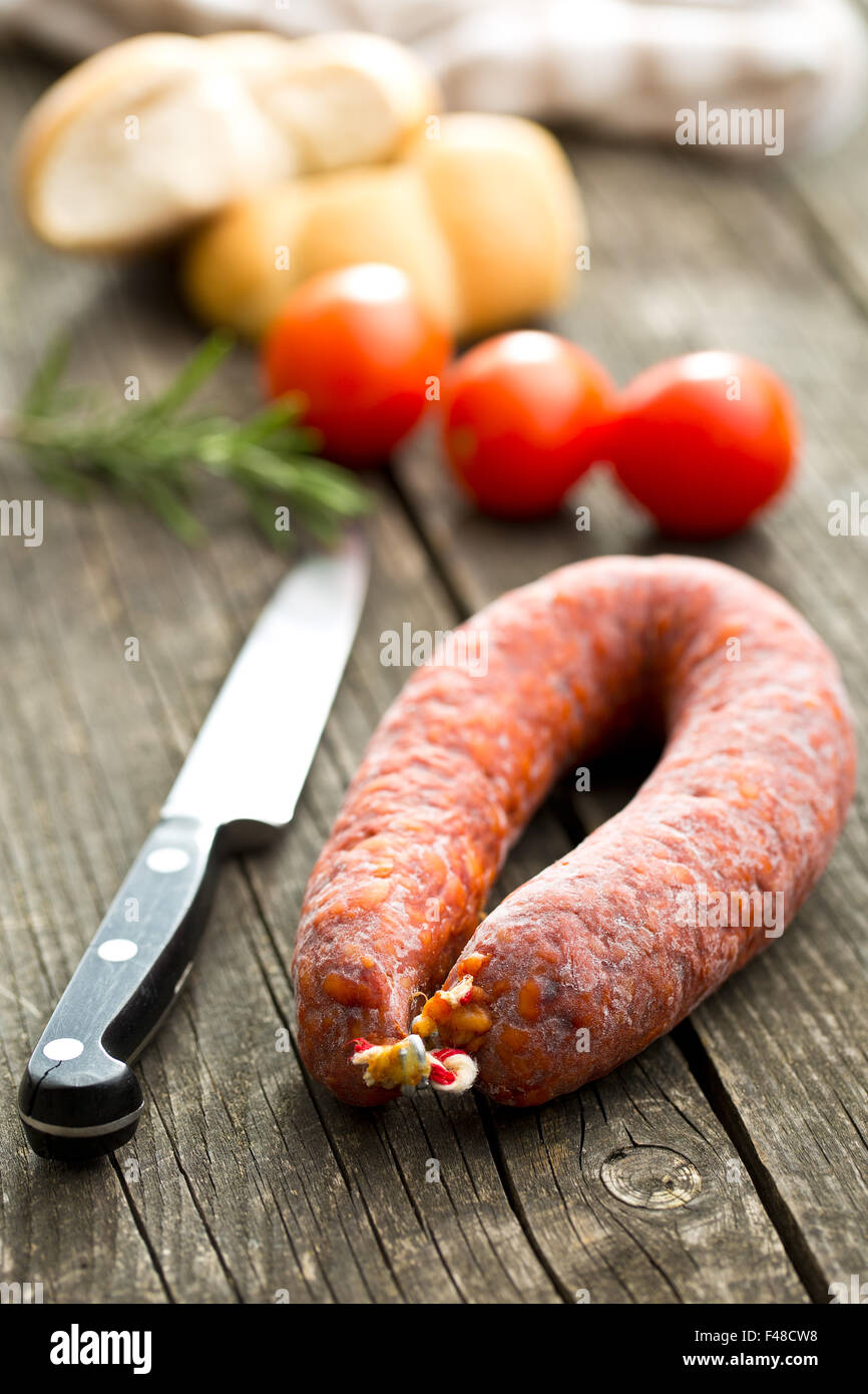 Chorizo sausage on old wooden table Stock Photo - Alamy