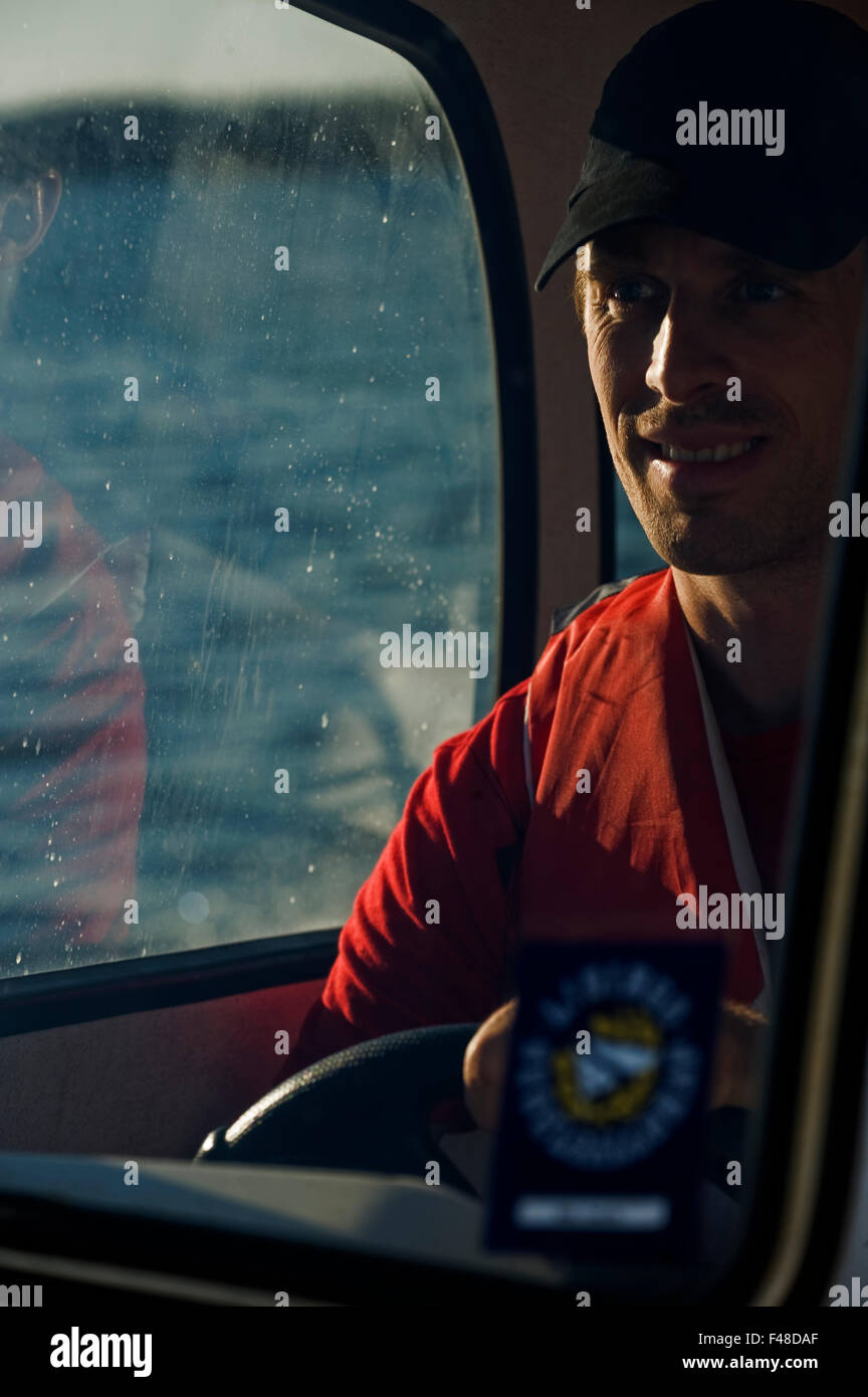 A man driving a motorboat, Sweden Stock Photo - Alamy