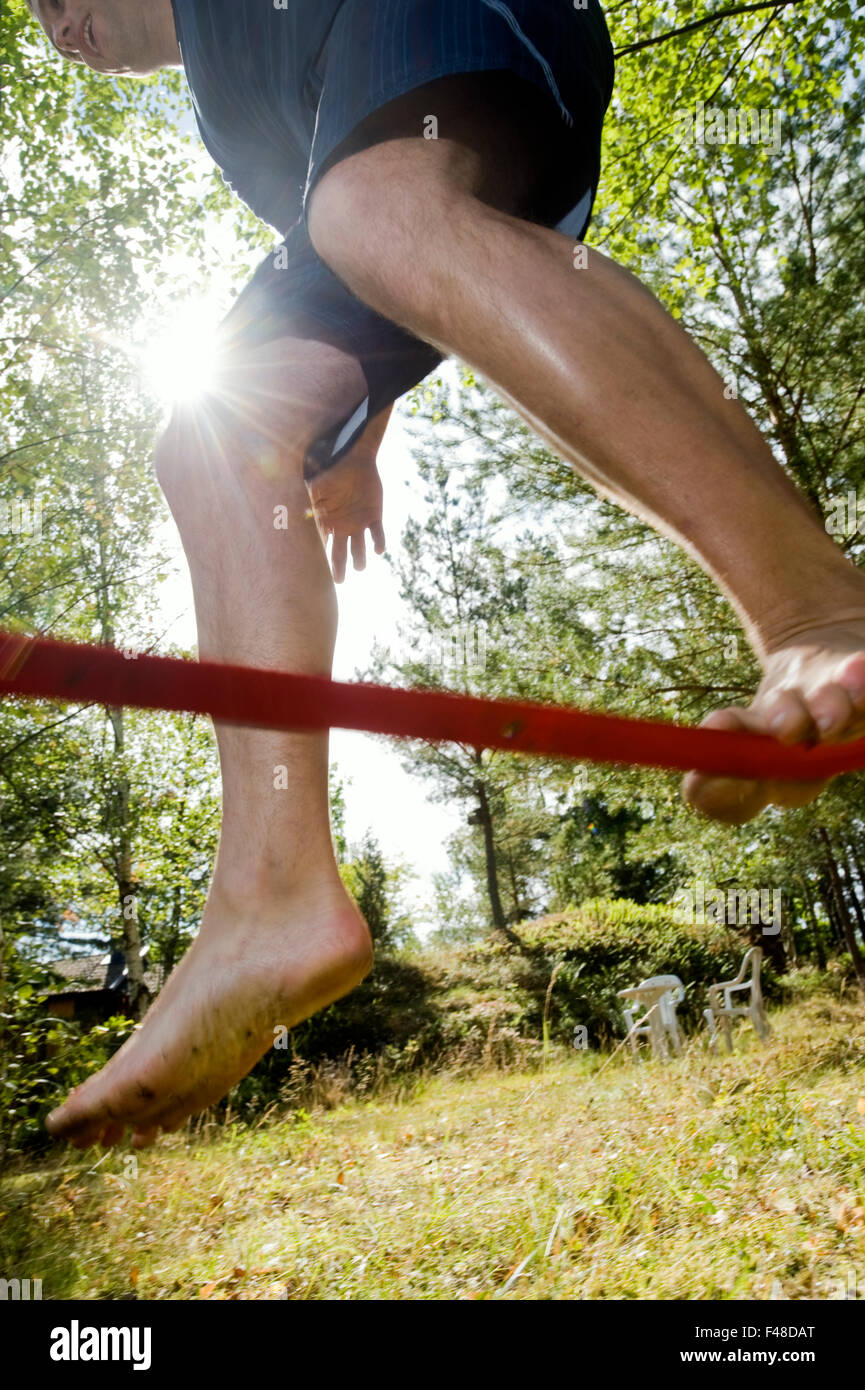 A person loosing the balance walking on a tightrope, Sweden. Stock Photo