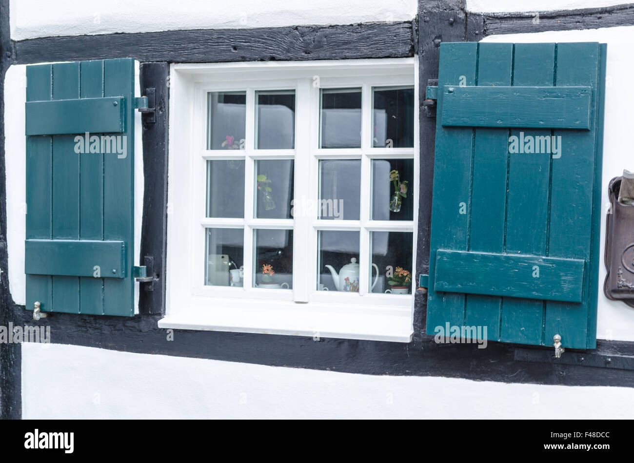 Shutters in front of a window Stock Photo