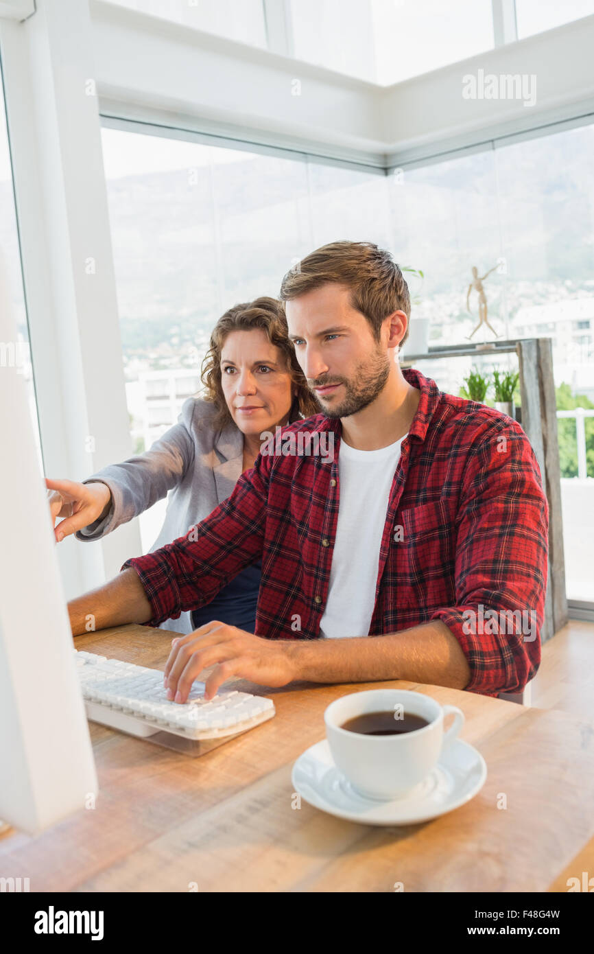 Creative business partners working on computer together Stock Photo - Alamy