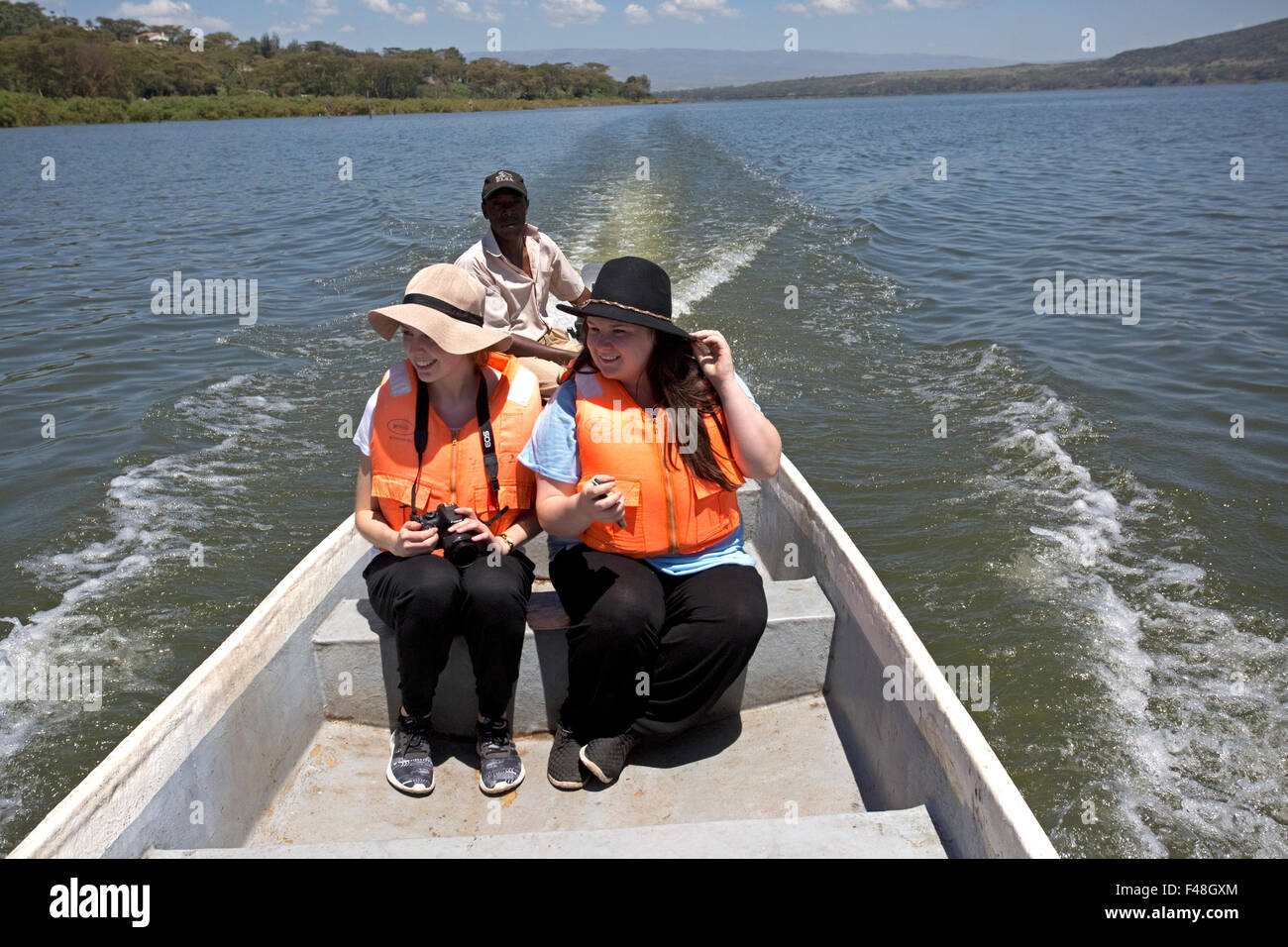 Tourists birdwatching from boat Lake Naivasha Kenya Stock Photo