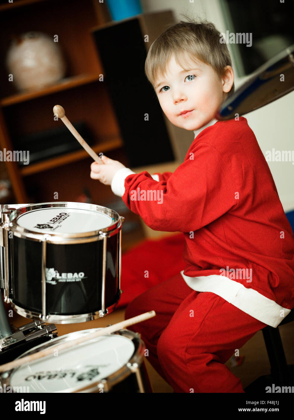 A little child playing the drums, Sweden Stock Photo Alamy