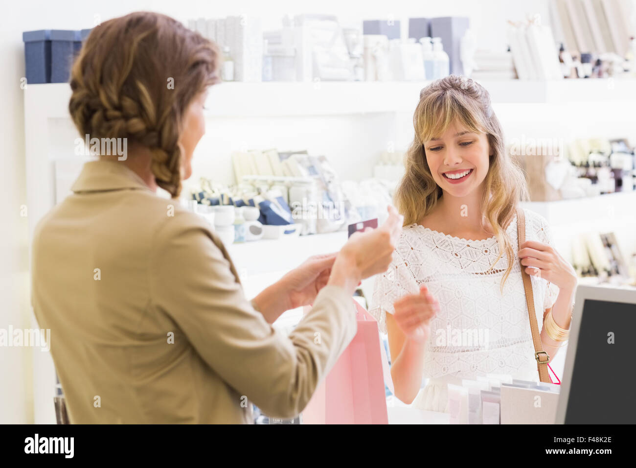 Beautiful employee and customer at cash register Stock Photo Alamy