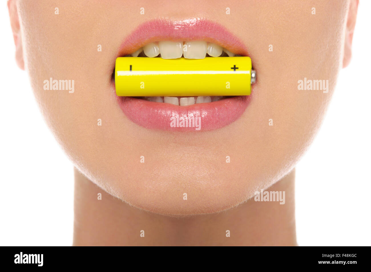 Woman holding battery in his mouth Stock Photo