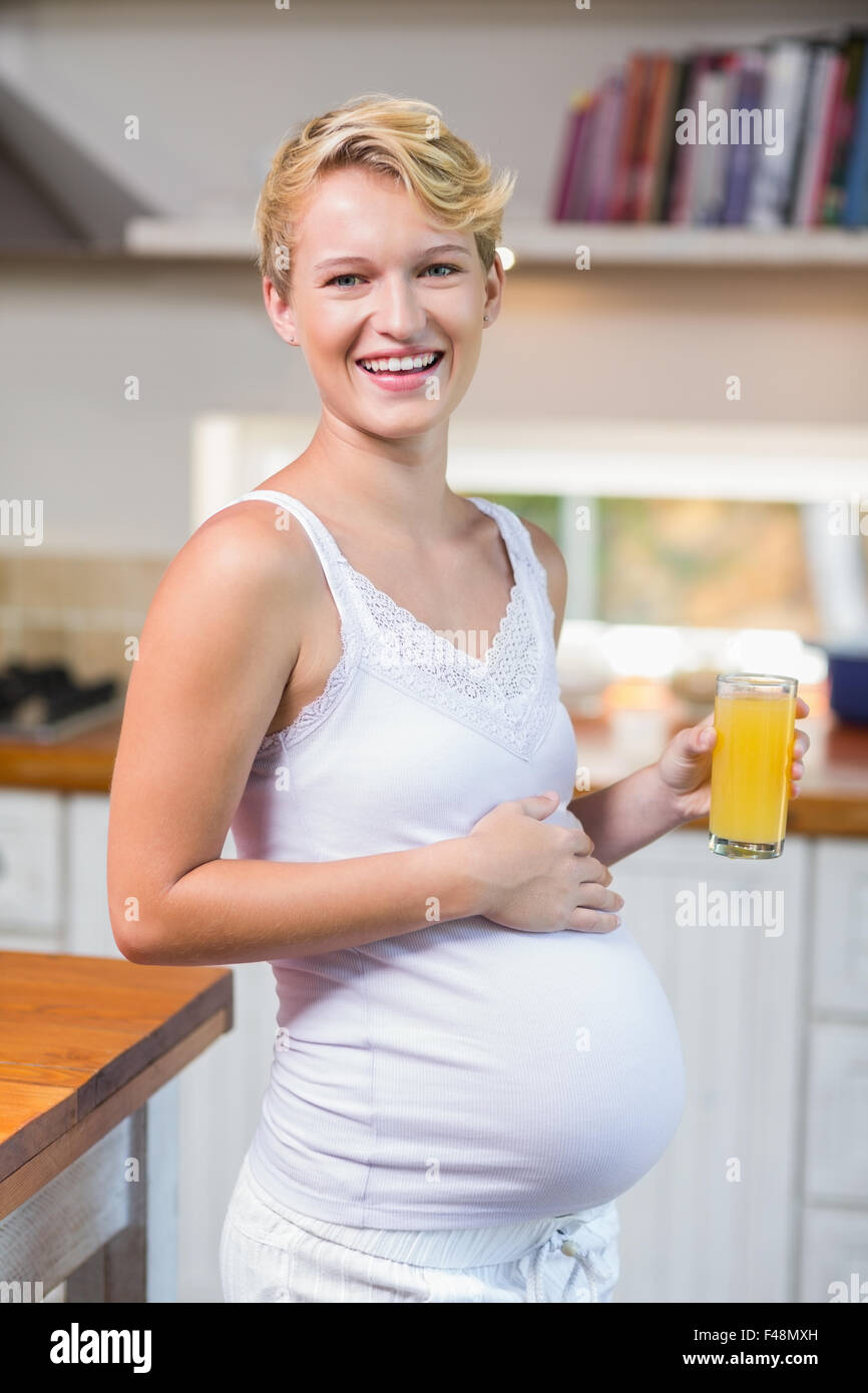 Pregnant woman drinking a orange juice glass Stock Photo Alamy